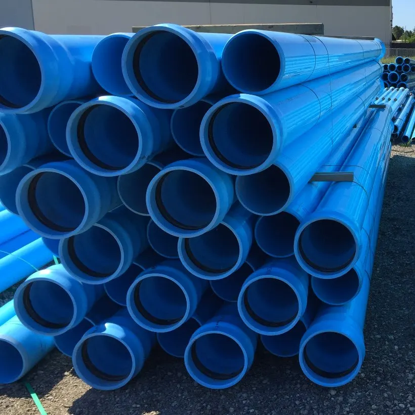 Stacked blue waterworks pipe stored on a project site.