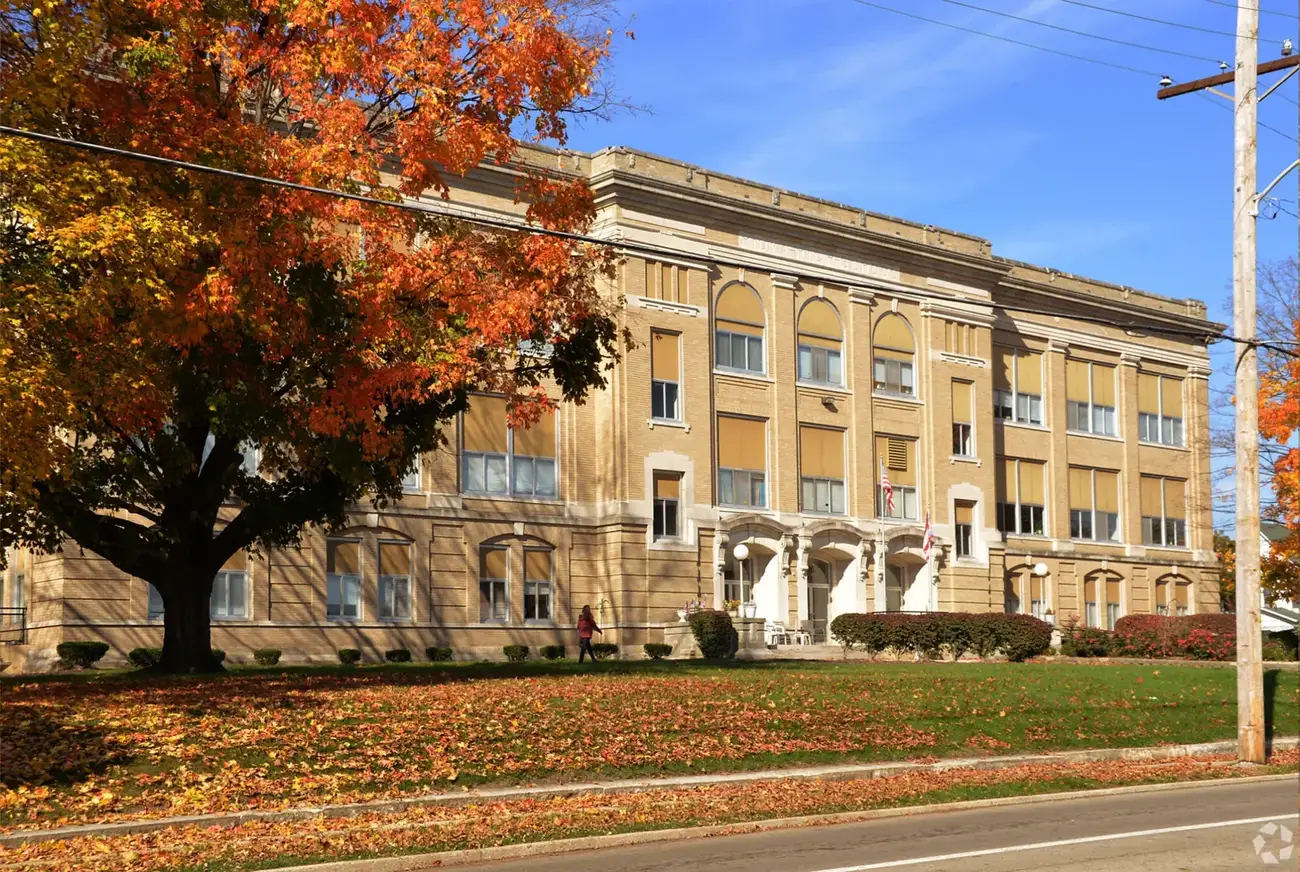 The Heritage Lofts, a restored brick-and-stone apartment building, in autumn.