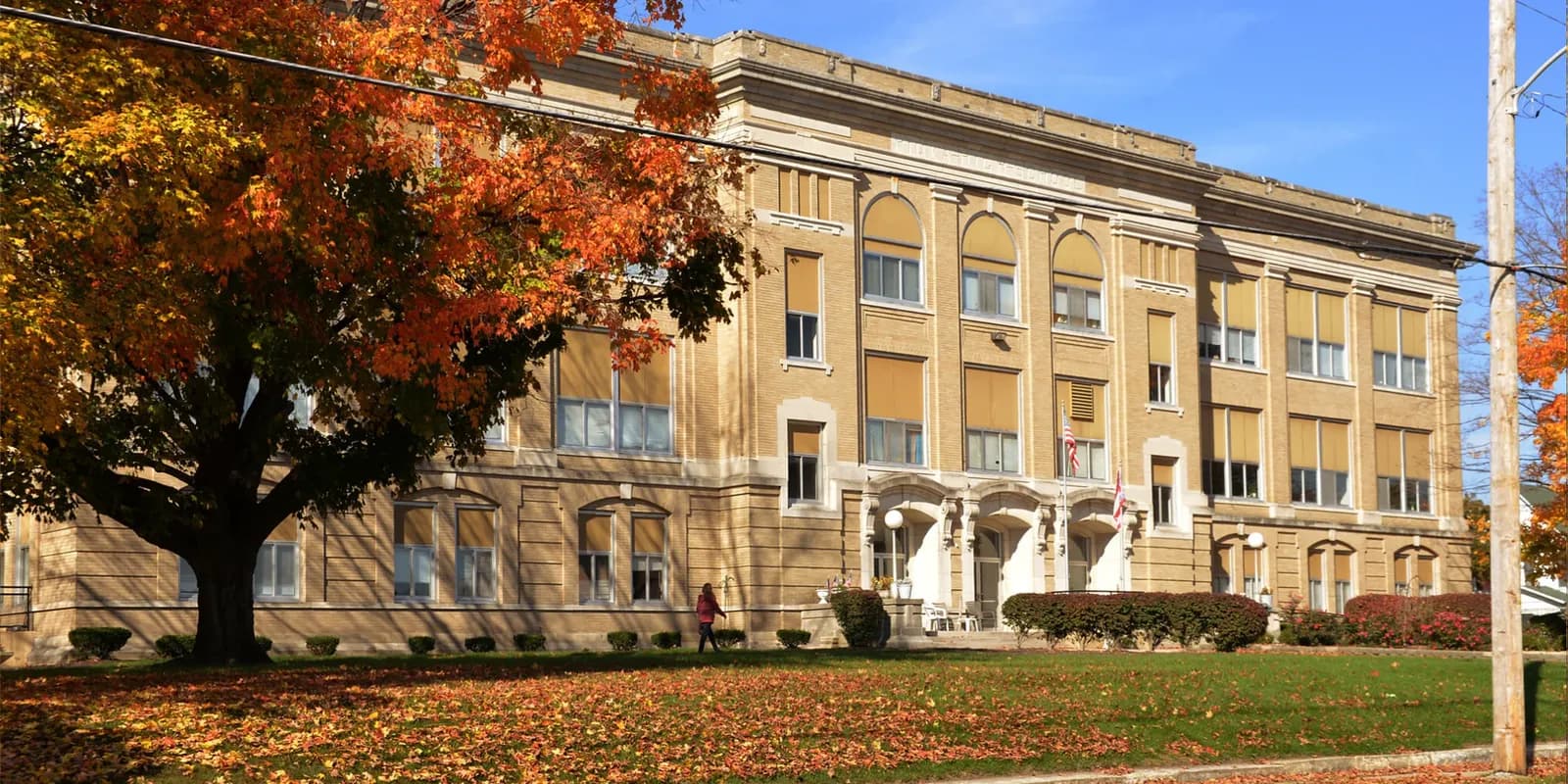 Heritage Lofts, a Real Estate Alpha apartment community in a restored brick and stone building, in autumn.