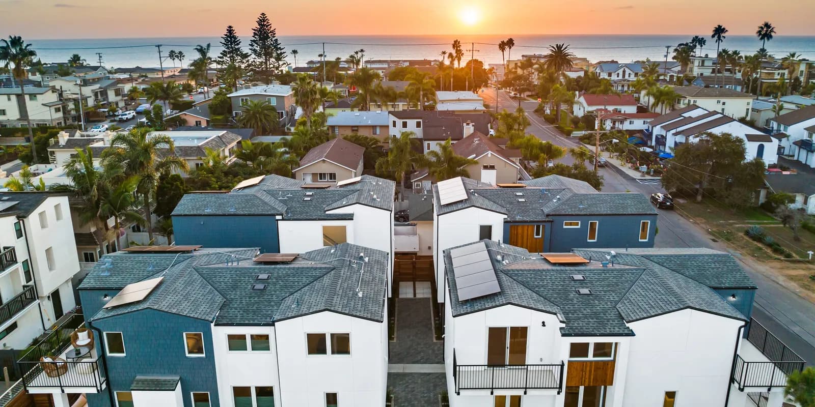 Rincon Homes houses in Carlsbad, California, at sunset with the Pacific beyond.